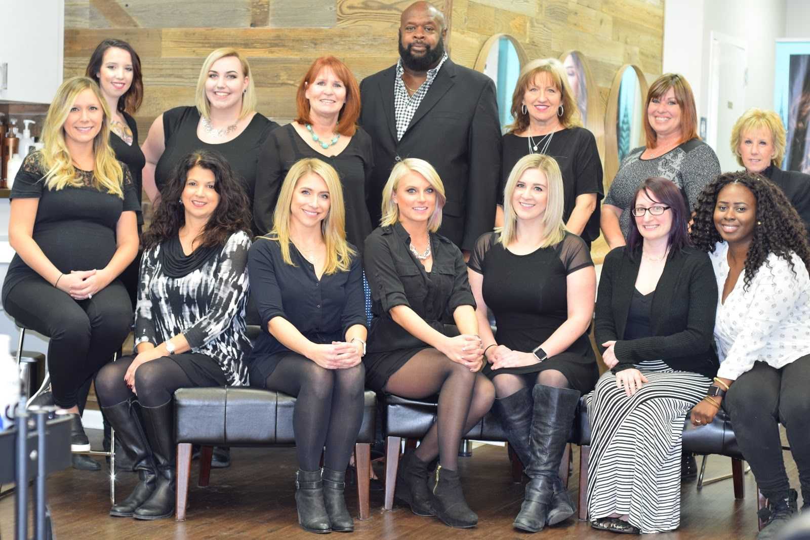 Group photo of salon team members posing together inside the salon.